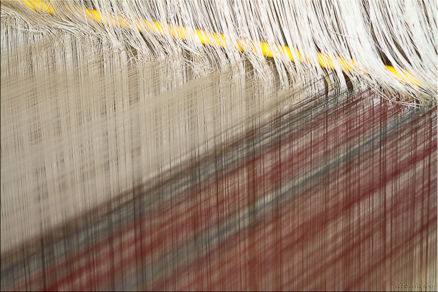 Close-up of silk threads on a large loom