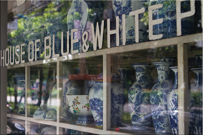 "House of Blue and White Pottery" Shop front, with shelves of pots behind glass