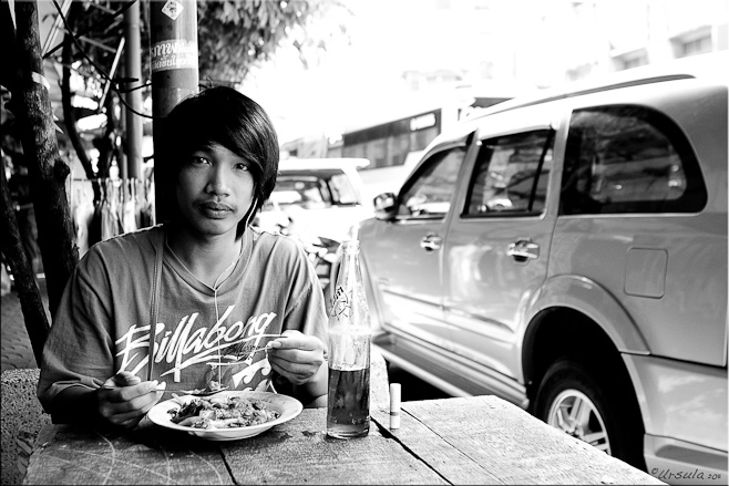 B&W Young thai man eating noodles