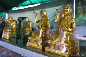 Golden figurines (Mae Nang Kwak) in celephane