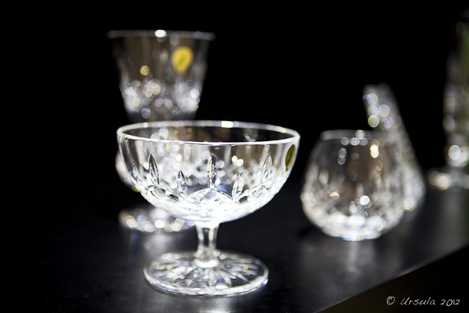 Crystal sweet bowl and wine glass against a black background.