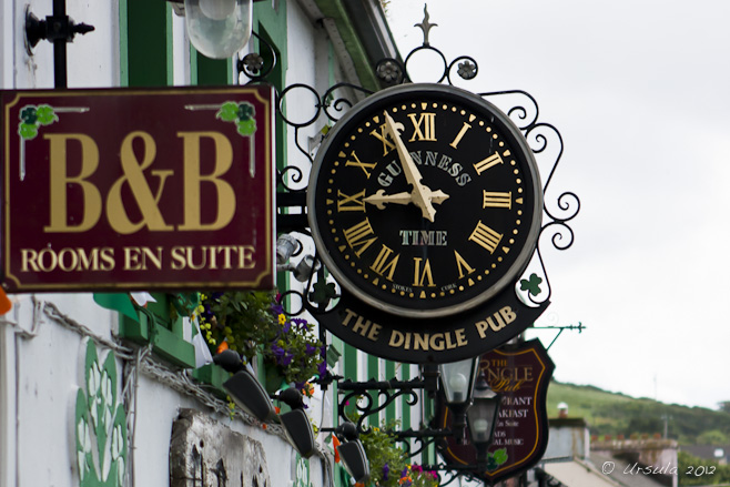 Ornate clock above the Dingle Pub doorway; B&B sign. Dingle, Ireland