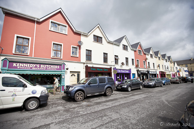 Colourful row-shop-fronts under a tray sky. Dingle, CoKerry, Ireland