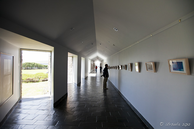 Visitors looking at photographs in a hallway in the Great Blasket Centre, Dunquin, Ireland