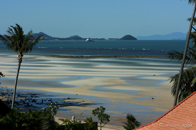 View over sand flats towards Na Thon Pier and Ferry Terminal, Koh Samui, Thailand.