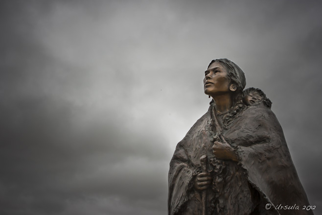 Sculpture of Sacagawea and baby Jean Baptist by Glenna Goodacre, against a gloomy grey sky; Buffalo Bill Historical Center, Cody, WY