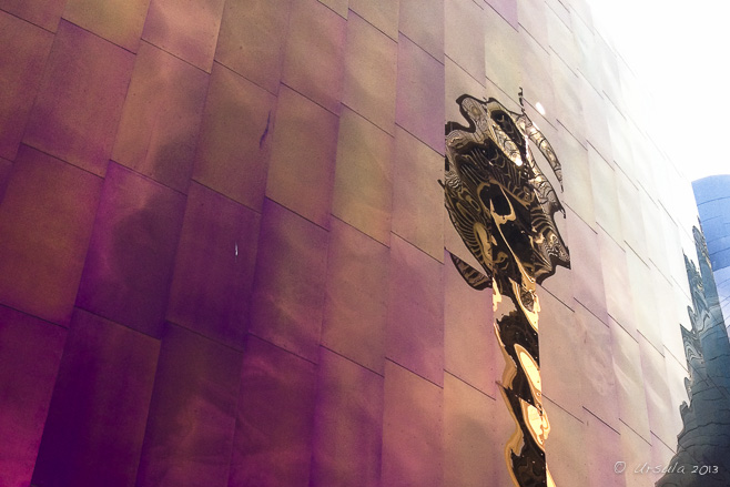 Reflection of a golden Seattle Space Needle in the pink metallic side of the EMP building, Seattle Centre, WA, USA