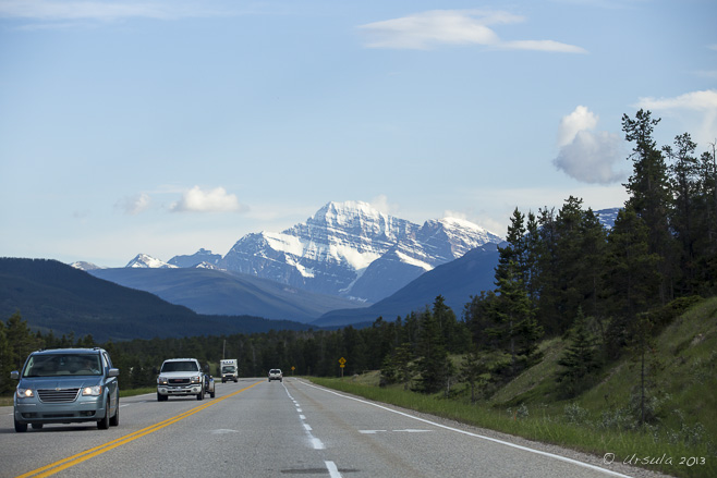 View of mountains, highway and oncoming traffic, Yellowhead Highway, east of Jasper, Alberta.