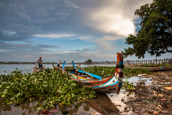 View over the painted wooden boats on Taungthaman Lake to U Bein Bridge, Amarapura, Myanmar