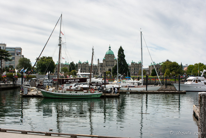 View of Victoria Harbour, sailboats foreground, the British Columbia Legislature Building in the background.