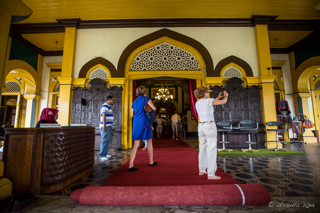 Tourists on the red carpet outside Maimoon Palace, Medan.