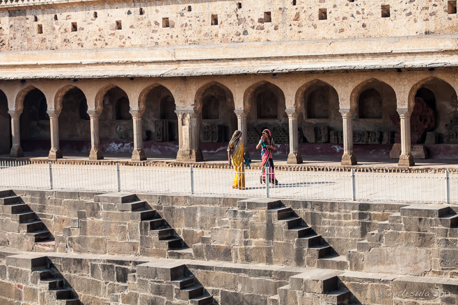 Two Women in Saris walking around the Chand Baori Stepwell,  Abhaneri, Rajasthan