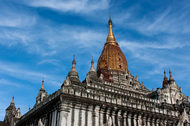 Golden roof of Ananda Temple against a blue sky