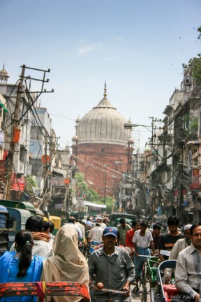 The dome of Jama Mosque from the crowded streets of Old Delhi