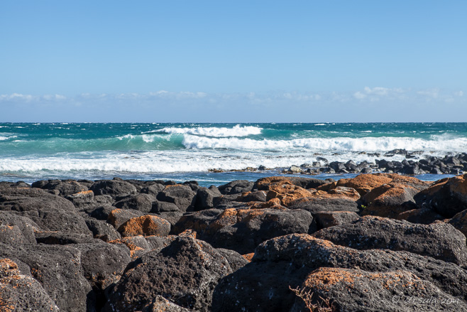 Waterfront: turquoise waters, black rocks with red rust, Port Fairy, VIC