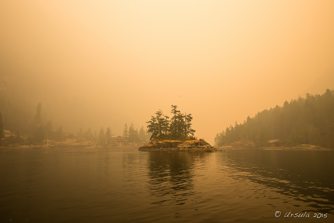 Entrance to Princess Louisa Inlet in and orange light from forest fire smoke, BC