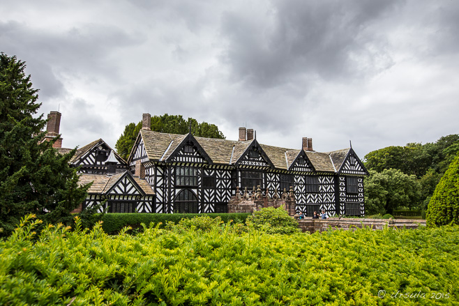 Speke Hall, Liverpool behind green shrubbery, UK