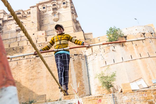 Young boy walking a tight rope, Jaisalmer Fort, India