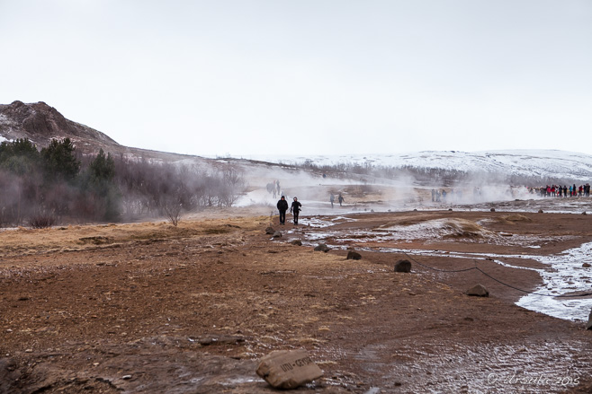 People silhouetted against the steam from Litli Geysir, Haukadalur, Iceland