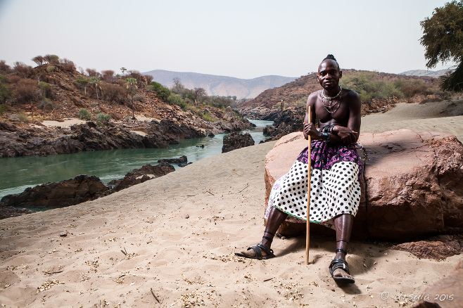 An unmarried Himba Male on the banks of the Kunene River, Namibia