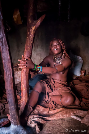 Young Himba Woman in a dark hut, Kunene Region Namibia