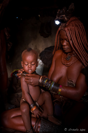 Himba Mother and Child in a dark hut, Kunene Region Namibia