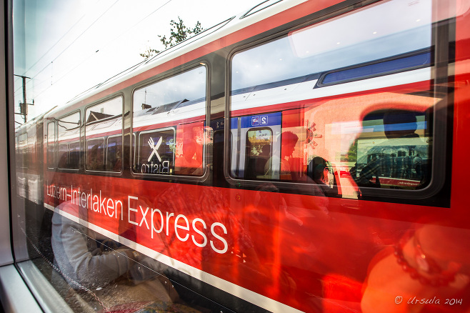 Reflections of Luzern-Interlaken Express trains in motion, Switzerland