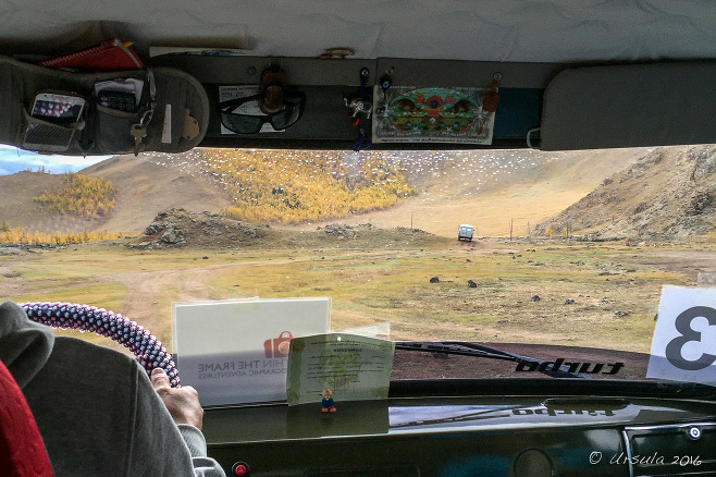 View from a UAZ windshield over dusty hills, Terkhiin Tsagaan Nuur, Mongolia