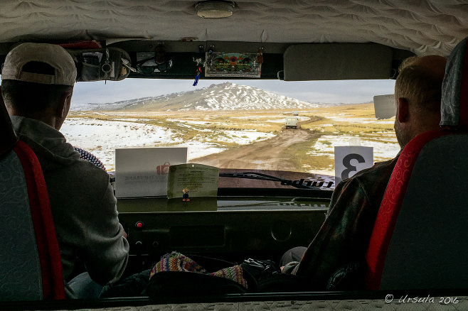 View from a UAZ windshield over snowy hills, Uvs Mongolia