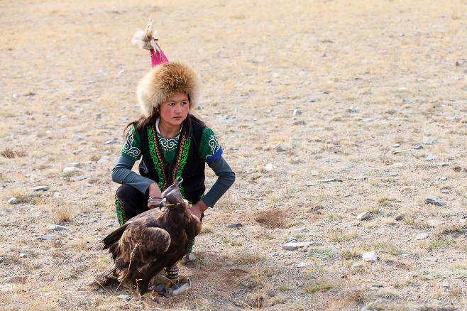 Mongolian girl in Kazakh eagle hunter costume with her eagle, Bayan-Ölgii Mongolia