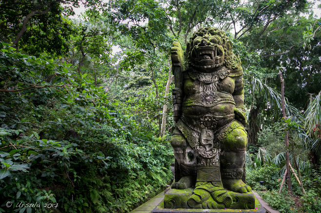 Moss and lichen covered Monkey Guardian statue, Monkey Forest Ubud Bali