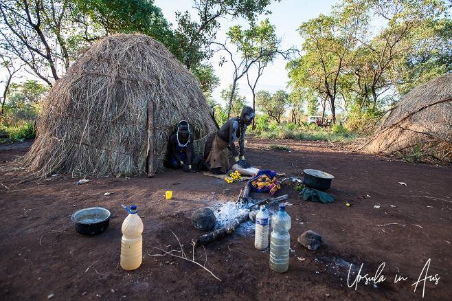 Woman working a grinding stone, Mursi village, Ethiopia