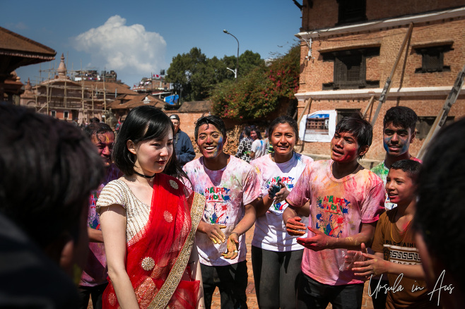 Chinese model in a crowd of Nepali Holi celebrants, Bhaktapur, Nepal