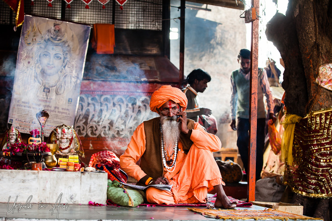 Seated sadhu on a mobile phone, Pushkar India