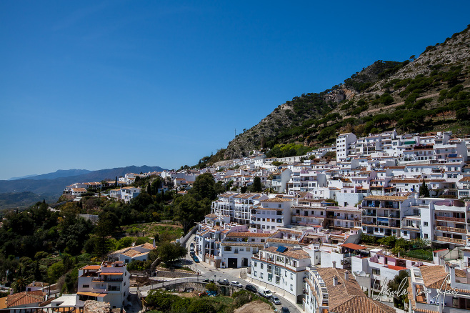 White buildings of Mijas against the hills and sky, Spain