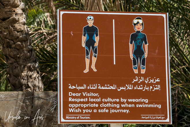 Signpost depicting modest clothing, Wadi Bani Khalid, Oman