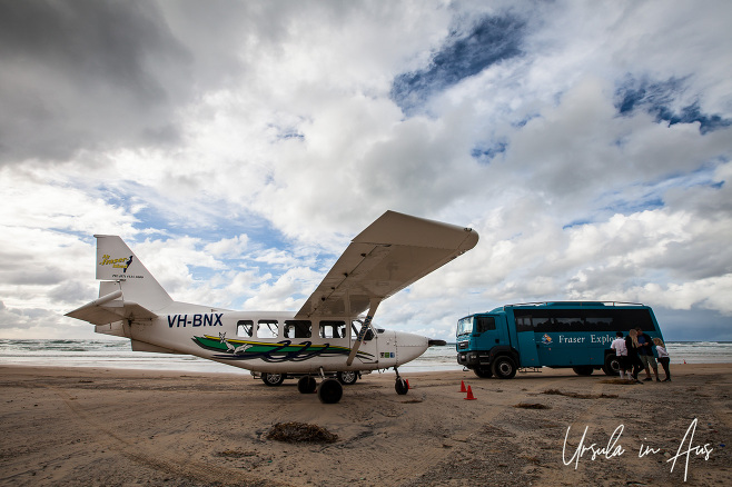 Air Fraser Island plane and a Fraser Explorer MAN bus on Seventy-Five Mile Beach, Queensland Australia