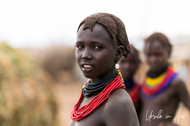 Young Daasanach Teen in red and black beads, Omo Valley Ethiopia