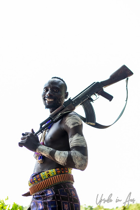 Portrait: Kara man with an automatic weapon, Omo Valley Ethiopia