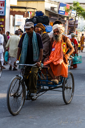 Two sadhus in a bicycle riskshaw, Haridwar India