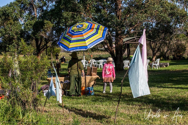 Colourful umbrella and people, Panboola Wetlands, Pambula NSW Australia.