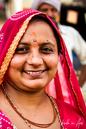 Portrait: Indian Woman in a red ghoonghat, Varanasi ghats, India.