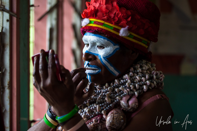 Portrait: Western Highlands Woman applying face paint, Mt Hagen PNG