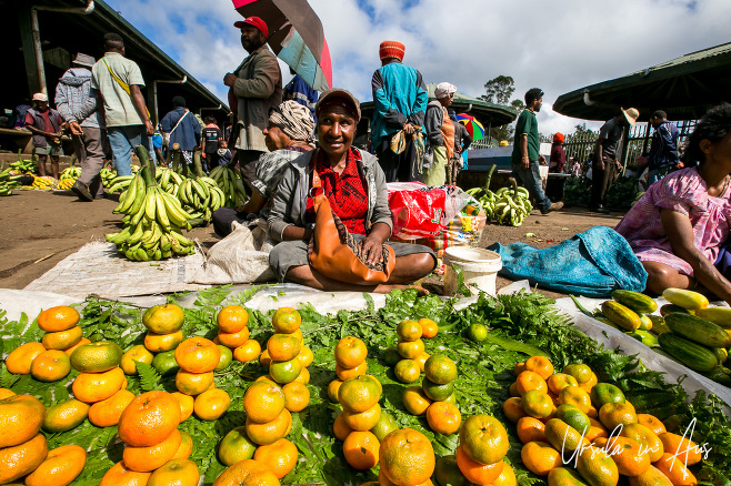 Papuan woman with stacks of oranges, Mount Hagen Market, PNG