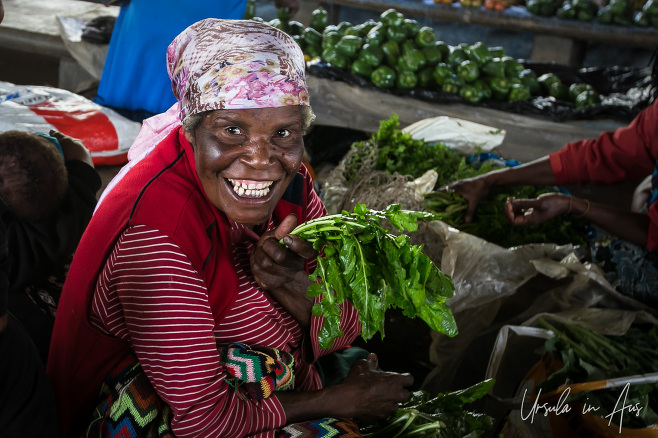 Portrait: Papuan woman with green vegetables, Mount Hagen Market, PNG