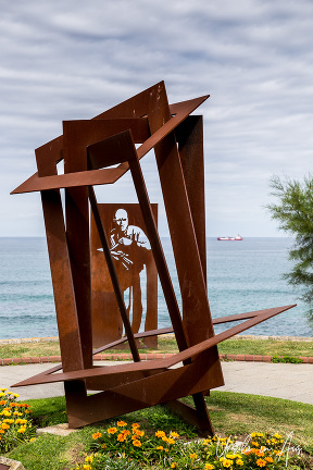 Sheet metal sculpture of painter Enrique Gran above Playa del Camello, Santander Spain