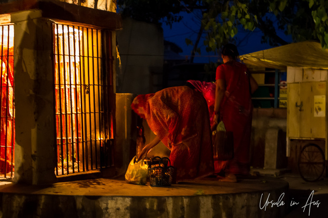 Women in saris outside a Shiva shrine, Assi Ghat, Varanasi India