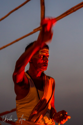 Hindu priest performing an aarti pre-dawn, Assi Ghat, Varanasi India