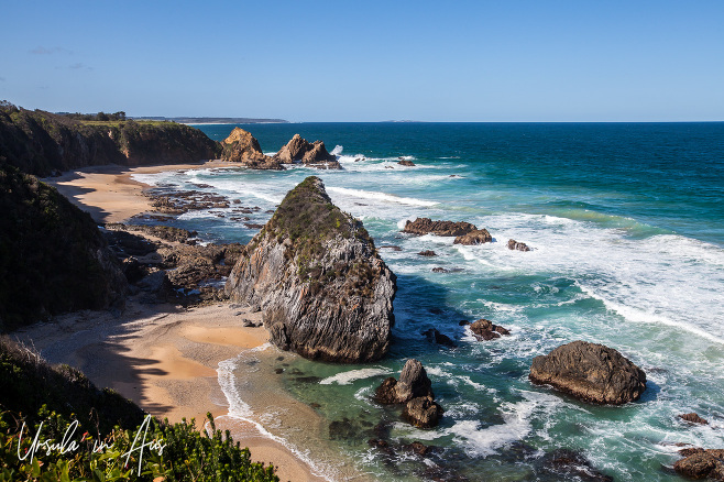 Rocky outcrops and blue and white waters from the Bermagui Coast Walk, NSW Australlia