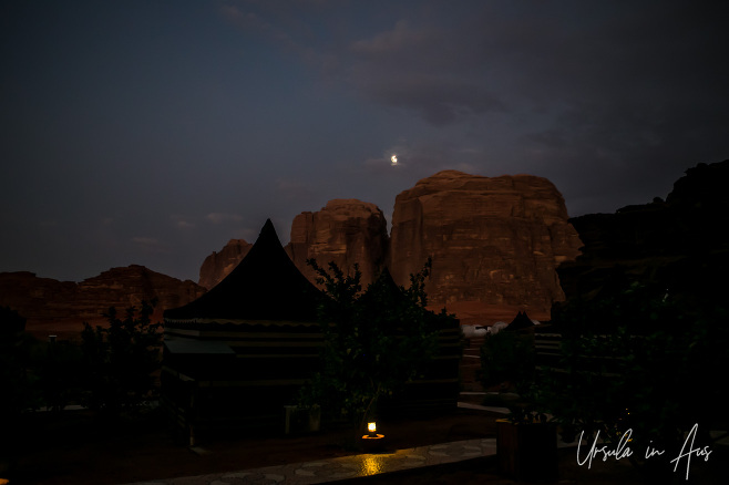 A waning gibbous moon over Wadi Rum Night Luxury Camp in Wadi Rum, Jordan